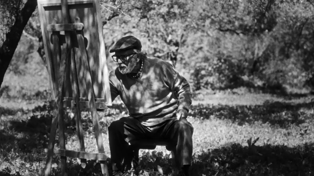 Escena de la pel&iacute;cula,  pintor a la sombra de un &aacute;rbol.