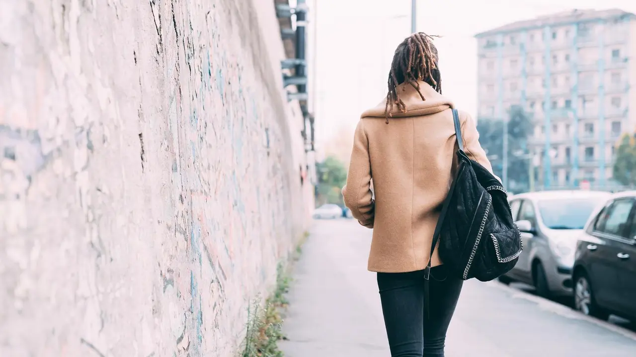 back view young woman walking outdoor