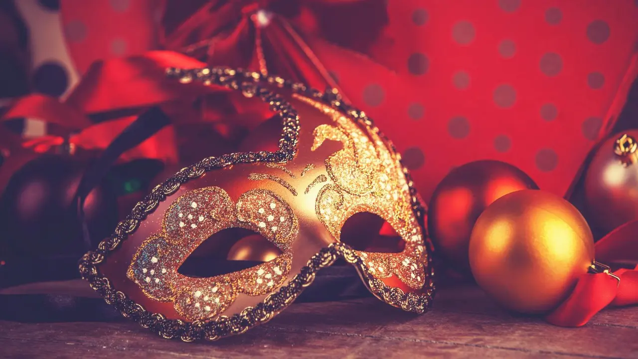 Mask for carnival near gifts. Photo in old color image style