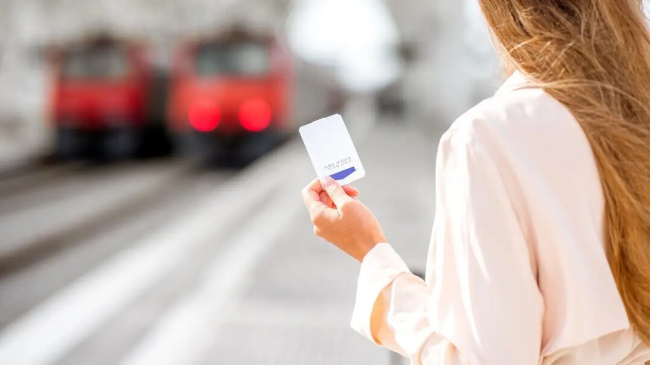 Mujer sosteniendo billete de metro. Imagen de archivo.