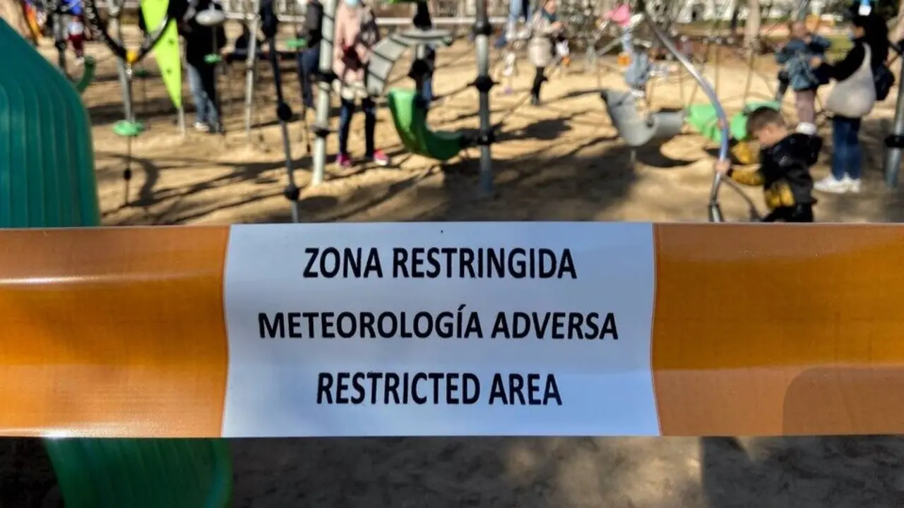 Un parque infantil restringido al paso con una cinta.